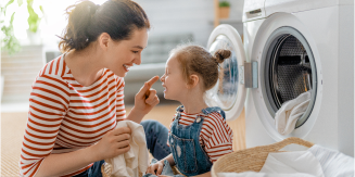 Woman using her washing machine during off-peak hours to save money and energy
